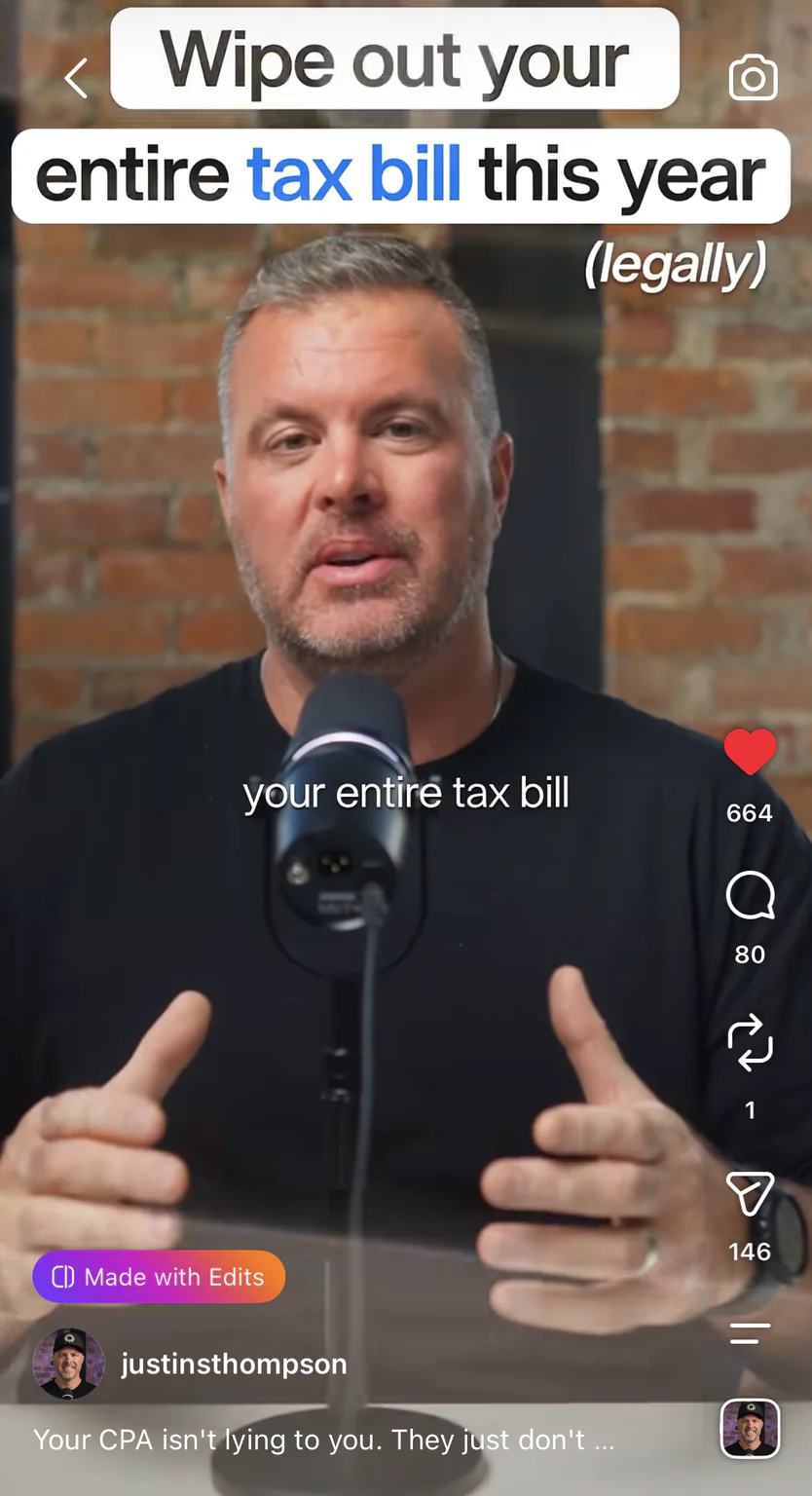 Justin Thompson filming a tax video in his brick recording studio with a microphone